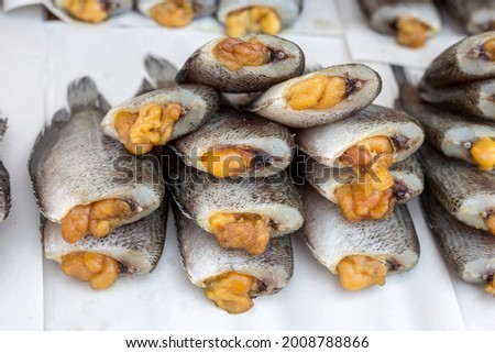 Dried gourami is having eggs at a street market in other provinces of Thailand. Focus in the middle of the picture.
