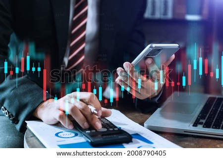 woman working at modern office.Technical price graph and indicator, red and Blue candlestick chart and stock trading tablet and computer

