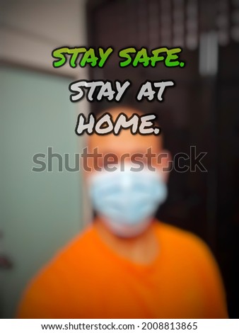 Inspirational life quote "STAY SAFE. STAY AT HOME." isolated on a blurry background.