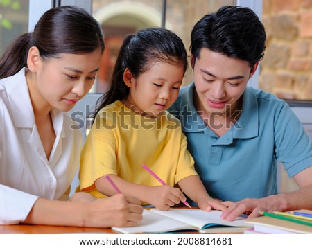 Young parents help their children with their homework high quality photo