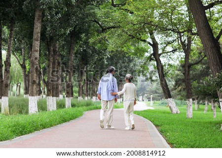 Happy old couple walking in the park high quality photo Royalty-Free Stock Photo #2008814912