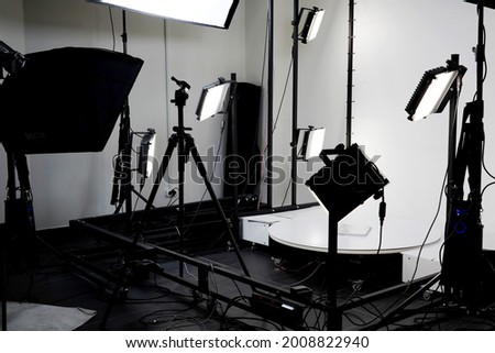 Large empty light white photo studio with light installations and softboxes ready for art