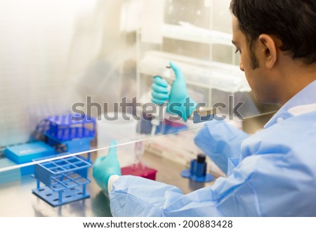 Closeup cropped portrait, scientist pipetting with hands, laboratory experiments, isolated lab background. Forensics, genetics, microbiology, biochemistry Royalty-Free Stock Photo #200883428