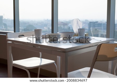 Enjoy the day view. The perfect place for a breakfast. A table for two. A gorgeous view from the panoramic Windows. View from a tall building.