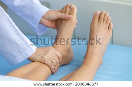 Doctor holds legs patient on bed in hospital and checkup nervous system for cure and treatment. Concept of Guillain barre syndrome and numb hands disease or vaccine side effect.