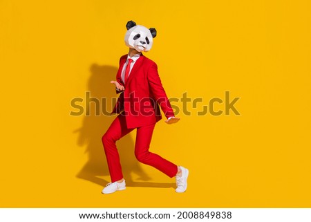 Photo of panda guy inspired affectionate dance moves wear mask red tux shoes isolated on yellow color background