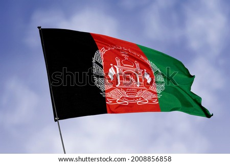 Afghanistan flag isolated on sky background. National symbol of Afghanistan. Close up waving flag with clipping path.