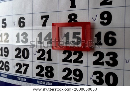 Wall calendar with marks. The 15th number is marked