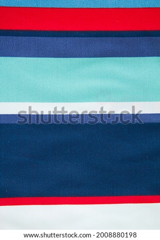 Colorful bright summer red,blue,white,white striped fabric.Fabric texture,background for design.