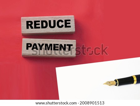 Wooden blocks with the words Reduce payment. Business concept.