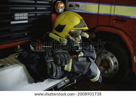 protective firefighter uniform  fire helmet, protective pants, protective jacket and gloves 