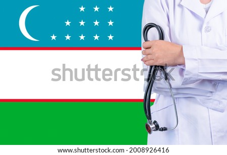 Female doctor with stethoscope in hand on the background of the Uzbekistan flag. Concept medicine, pandemic in the country