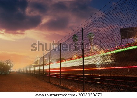 Long exposure shot of train moving towards downtown Los Angeles at night. Copyspace.