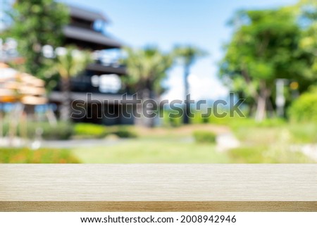 Empty wooden desk with blurry background of resort and spa.