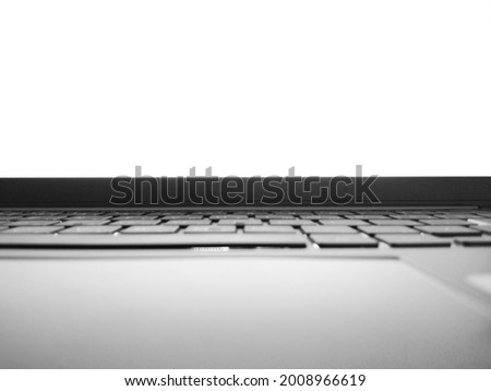 Black and white photo of ultrabook with keyboard and white blank screen with space for ad text