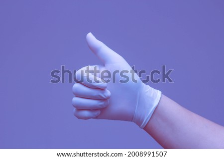 Hands in rubber gloves making the symbol "Excellent" against a blue background.