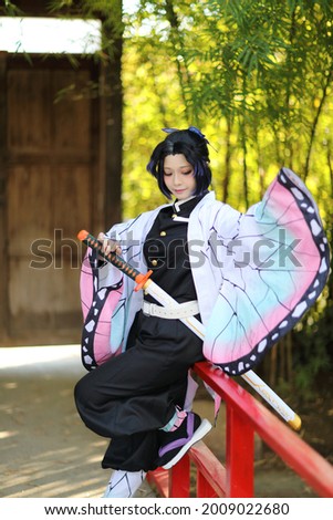 Japan anime cosplay portrait of girl with comic costume with japanese theme garden