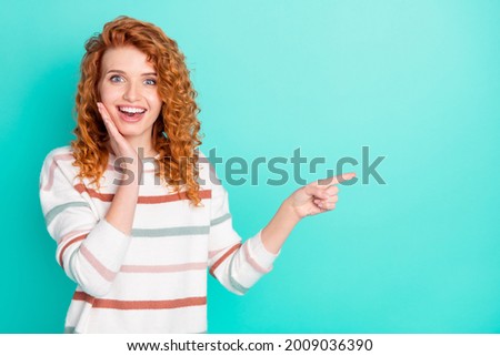 Portrait of attractive cheerful wavy-haired girl demonstrating copy space ad way isolated over bright teal turquoise color background