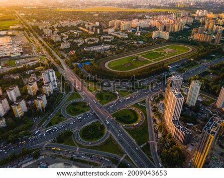 Aerial view from a drone of a highway road in the city at sunset