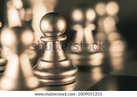 A black pawn on a chessboard