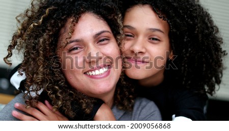 Mother and daughter spontaneous love and hug. Child and parent portrait