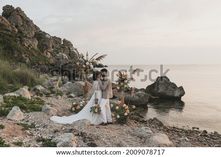 Bride and groom are kissing. Eco wedding in bogo and lifestyle with art grain.  Royalty-Free Stock Photo #2009078717