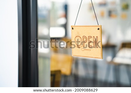 Open board sign hang on the window.