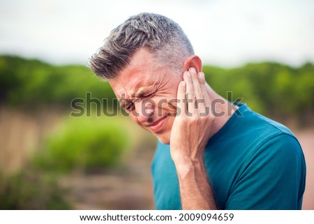 Ear pain. Man with otitis outdoor. Healthcare and medicine concept Royalty-Free Stock Photo #2009094659