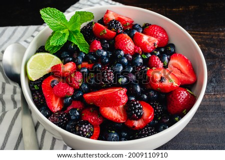 Summer Berry Salad with Garnish: Fruit salad made with strawberries, blueberries, blackberries, and raspberries