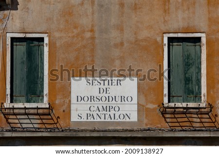 signage sestier de Dorsoduro - Quarter Dorsoduro and Campo San Pantalon, Place of San Pantalon at the grunge wall in Venice at an old grunge house wall Royalty-Free Stock Photo #2009138927