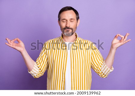 Photo of calm peaceful mature relaxed man make om signs asana good mood isolated on purple color background
