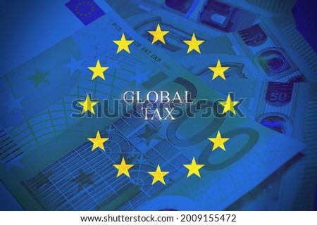 Banknote of 200 hundred euros on the table with the European Flag and the text "Global tax"