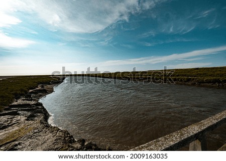 The scenic cloudy sky over a wide river in the countryside