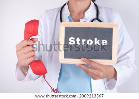 A blackboard with ''Stroke'' written on it in the hands of a doctor on a white background