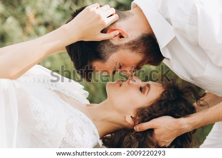 Bride and groom are kissing. Eco wedding in bogo and lifestyle.  Royalty-Free Stock Photo #2009220293