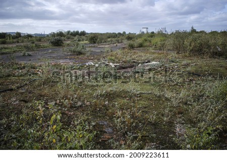 Brownfield land, site of former pesticide factory, recently demolished, and awaiting remediation and redevelopment  Royalty-Free Stock Photo #2009223611