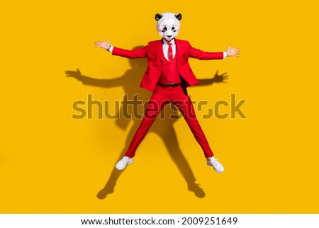 Photo of wacky panda guy jump have fun wear mask red tuxedo shoes isolated on yellow color background