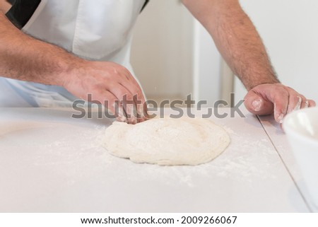 chef's hands shaping pizza dough