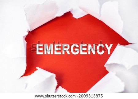 A white torn sheet in the center of which is a red background with the inscription emergency