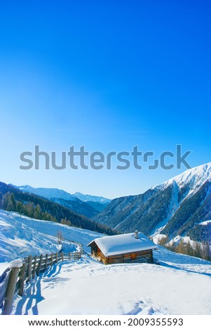 Switzerland, Alps, chalet on the top of the mountain with thick snow, long shot