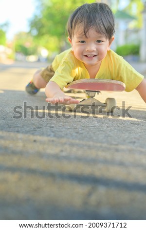 Asian little boy on skate board.The boy learns to skate