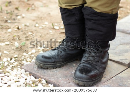 Military boots. Soldier's boots. Ankle boots on the legs.