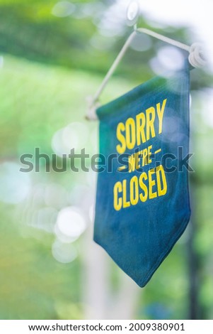 Sorry, we are closed. Sorry we are closed signboard with a rope on door store. Services concept for closed businesses. Close time businesses