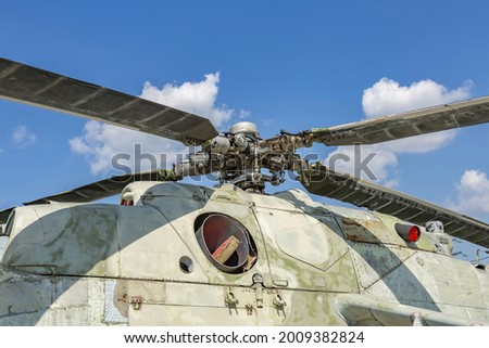Powerful propeller and blades of a military helicopter against the background of a bright blue sky