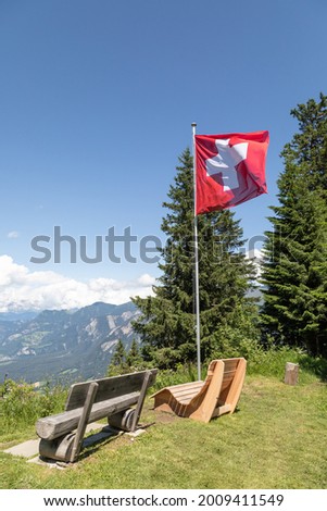 viewpoint with wooden benches on chur's local mountain