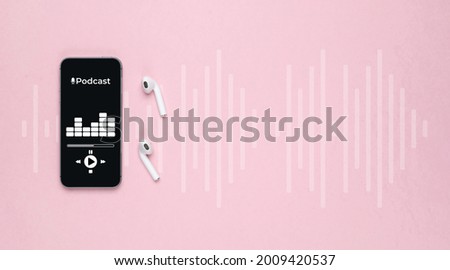 Podcast background. Mobile smartphone screen with podcast application, sound headphones. Audio voice with radio microphone on pink. Recording studio or podcasting banner with copy space