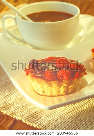 cup of coffee and fruity tarts. Picture in artistic retro style.