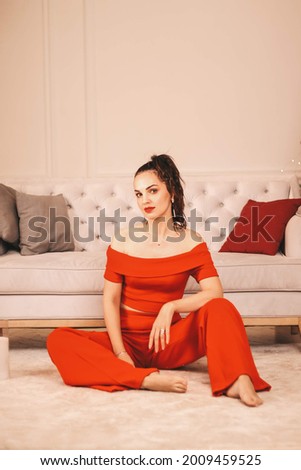  New Year's photo session of the girl. girl in a red suit against the background of a beautiful Christmas tree