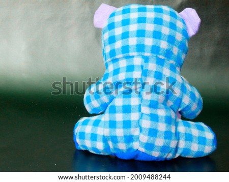 Teddy bear Animal soft toy displayed on blue check pattern, kids playing object image
