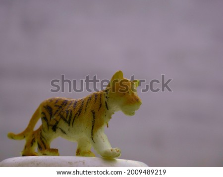 Baby tiger toy animal isolate at natural white wall background, kids playing object natural image.